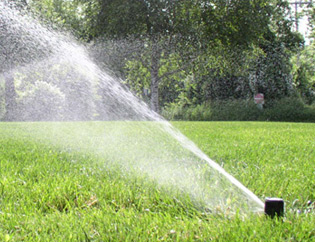 Image of sprinkler watering a lawn