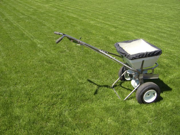 Image of fertilizer spreader in a sea of grass